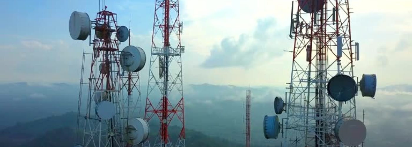 Aerial view of Telecommunication mast TV antennas with fog in the city